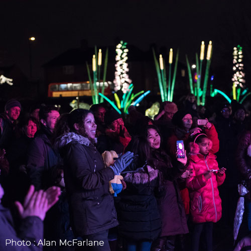 Crowds watching a performance at the Thornton Heath Light Festival